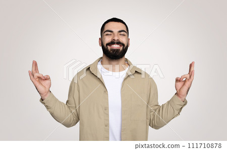 Smiling handsome young latin guy with beard with closed eyes, meditation 111710878