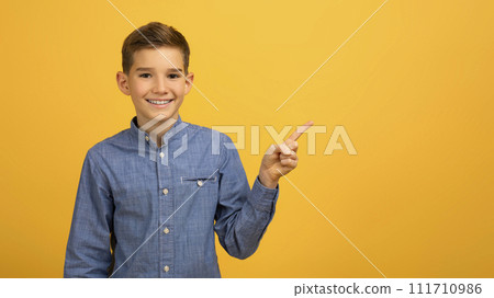 Check This. Happy Male Kid Pointing Aside At Copy Space With Finger 111710986