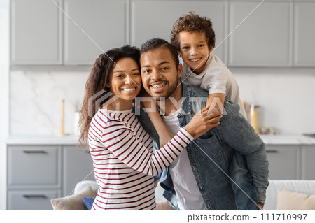 Happy Black Parents And Their Preteen Son Bonding At Home 111710997