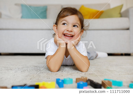 Dreamy Cute Toddler Girl Lying On Floor In Living Room Interior 111711000