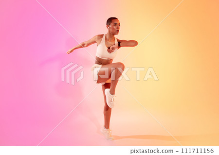 Focused millennial latin woman in sportswear, wireless headphones run, jump, make active workout, listen music Focused millennial latin woman in sportswear, wireless headphones run, jump, make active workout, listen music 111711156