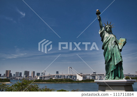 Statue of Liberty and Rainbow Bridge floating in Tokyo Bay, Tokyo, Japan 111711884