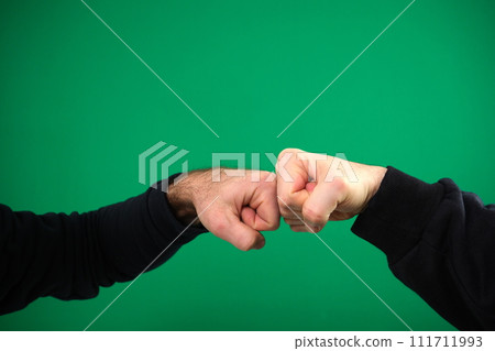 Closeup of man shaking hands Business handshake of business people on background Male hands isolated abstract background with . advertising Green background chromakey copy space Closeup of man shaking hands Business handshake of business people on background Male hands isolated abstract background with . advertising Green background chromakey copy space 111711993