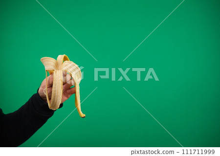 Skin from banana in the male hand, isolated. advertising Green background chromakey banana skin hand Skin from banana in the male hand, isolated. advertising Green background chromakey banana skin hand 111711999