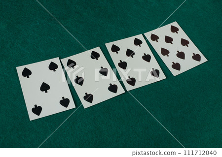 Old west era playing card on gambling table. 5, 6, 7, 8 of clubs. 111712040