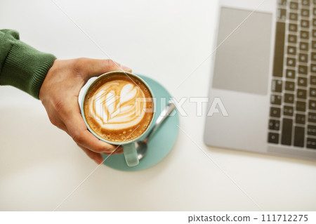 Top view of black guy drinking coffee at cafe Top view of black guy drinking coffee at cafe 111712275