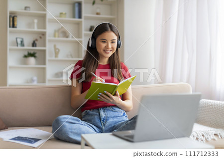 Young Asian Woman In Headset Study Online With Laptop From Home 111712333