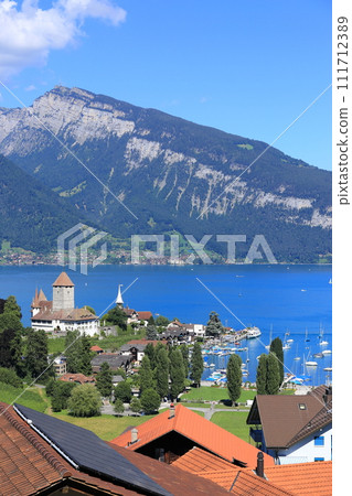 Summer Lake Thun and ferry terminal seen from Spiez station (Bern, Switzerland) 111712389