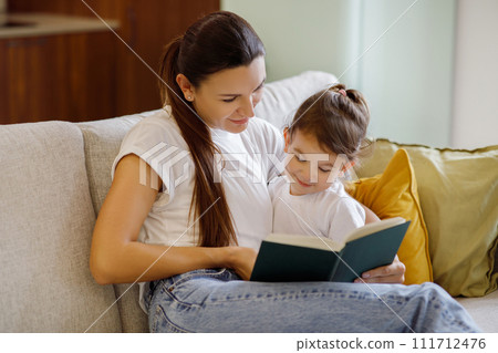 Baby Development. Mother Reading Book With Her Cute Toddler Daughter At Home 111712476