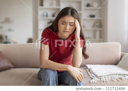 Anxious young asian woman suffering signs of headache or stress 111712484