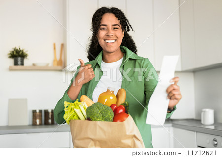 black lady reviews grocery list and giving thumbs up indoor black lady reviews grocery list and giving thumbs up indoor 111712621