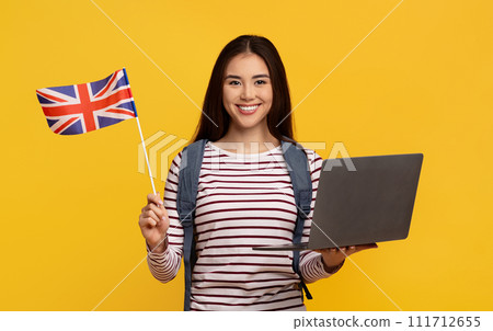 Cute asian woman student with laptop and flag of GB Cute asian woman student with laptop and flag of GB 111712655