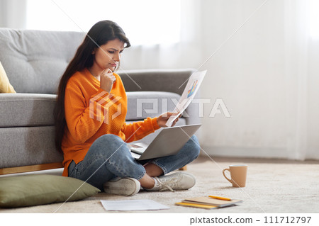 Upset young indian woman working from home, using laptop Upset young indian woman working from home, using laptop 111712797
