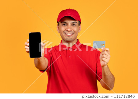 deliveryman with phone displaying credit card and empty screen, studio 111712840