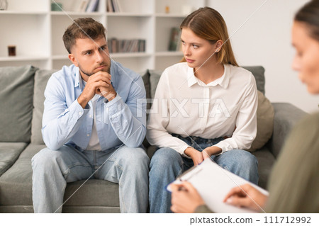Young couple having therapy session to navigate marital issues indoor 111712992