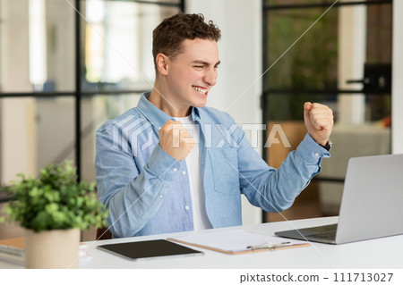 Happy excited millennial caucasian man manager rise fists, celebrate win Happy excited millennial caucasian man manager rise fists, celebrate win 111713027