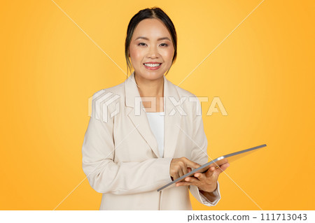 Positive confident young japanese businesswoman in suit, with tablet 111713043