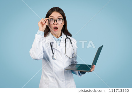 Surprised doctor with laptop, reacting to medical data Surprised doctor with laptop, reacting to medical data 111713360