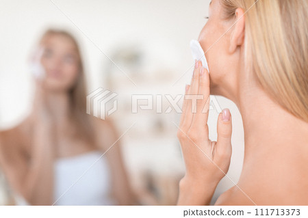 Cropped Of Woman Cleansing Face Skin With Cotton Pad Indoor Cropped Of Woman Cleansing Face Skin With Cotton Pad Indoor 111713373