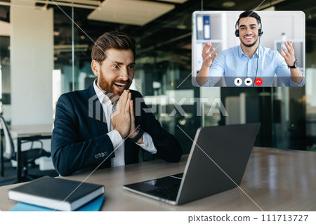Excited businessman celebrating great news and luck, have video chat 111713727