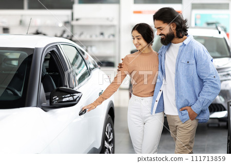 Beautiful young indian spouses choosing family car at showroom 111713859