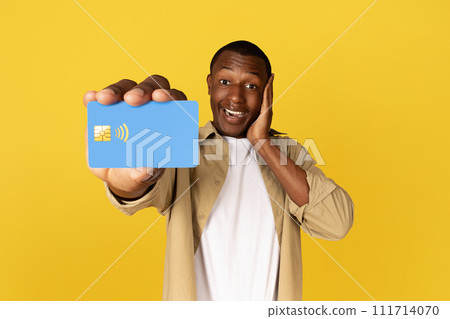 Happy millennial black guy in casual show credit card, enjoy shopping Happy millennial black guy in casual show credit card, enjoy shopping 111714070