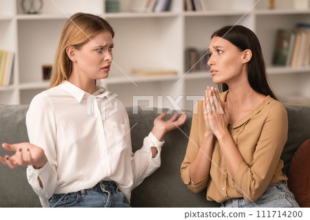 Confused Lady Shrugging Shoulders To Friend Asking For Favor Indoor 111714200