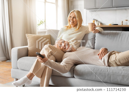 Relaxed elderly couple enjoying weekend together at home 111714230