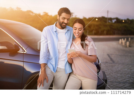 Arab couple using smartphone by car Arab couple using smartphone by car 111714279
