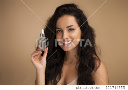 Beautiful woman showing beauty product at camera Beautiful woman showing beauty product at camera 111714355