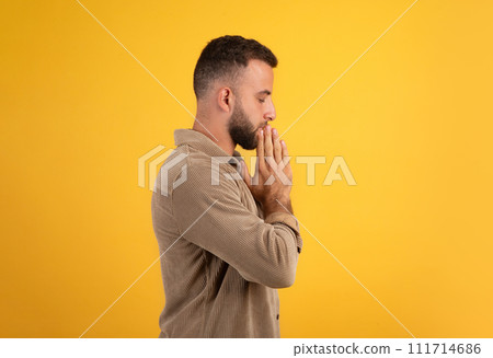 Serious calm millennial european guy make pray gesture, make a wish 111714686