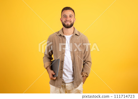 Smiling confident handsome millennial european guy hold laptop for work, business 111714723