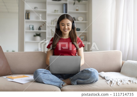 Distance Learning. Young Asian Woman In Headphones Studying With Laptop At Home 111714735