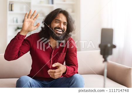 Positive young indian man blogger streaming from home 111714748