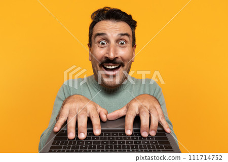Glad shocked funny senior european man typing on keyboard laptop, with open mouth Glad shocked funny senior european man typing on keyboard laptop, with open mouth 111714752