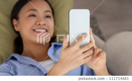 Top view of relaxed asian woman using smartphone 111714881