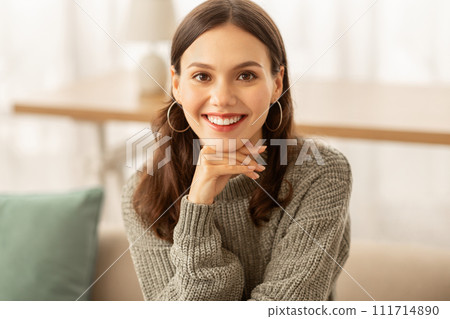 Portrait of cheerful brunette young woman posing at home 111714890