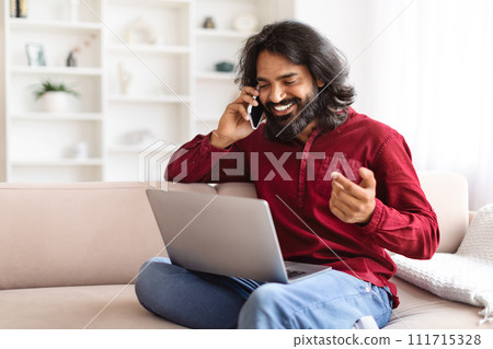 Wealthy indian man entrepreneur working from home, using laptop Wealthy indian man entrepreneur working from home, using laptop 111715328