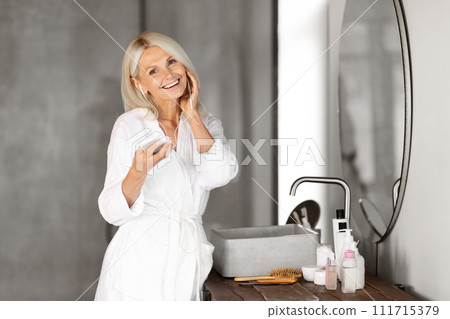 Beautiful Senior Woman In Earphones Listening Music On Smartphone In Bathroom Beautiful Senior Woman In Earphones Listening Music On Smartphone In Bathroom 111715379