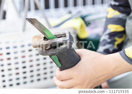Male hand holding a power tool 111715535