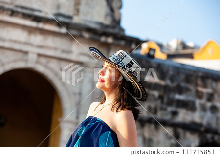 Beautiful woman wearing the traditional Colombian hat called Sombrero Vueltiao at the Peace Square on the historical streets of the Cartagena de Indias walled city Beautiful woman wearing the traditional Colombian hat called Sombrero Vueltiao at the Peace Square on the historical streets of the Cartagena de Indias walled city 111715851