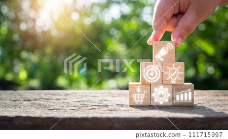 Advertising concept, Hand holding wooden block on desk with advertising icon on virtual screen. 111715997