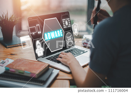 Adware concept, Business woman using laptop computer on office desk with adware icon on virtual screen. Adware concept, Business woman using laptop computer on office desk with adware icon on virtual screen. 111716004