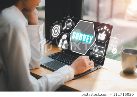 Survey concept, Business woman using laptop computer on desk with survey icon on virtual screen. 111716020