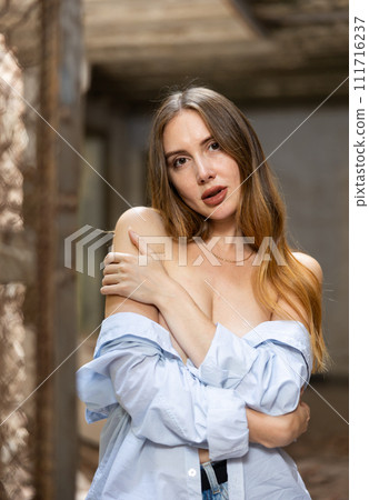Sensual woman undressing in deserted building 111716237
