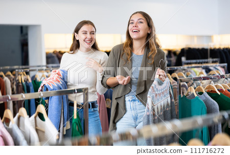 Two women shopping warm clothes in store Two women shopping warm clothes in store 111716272