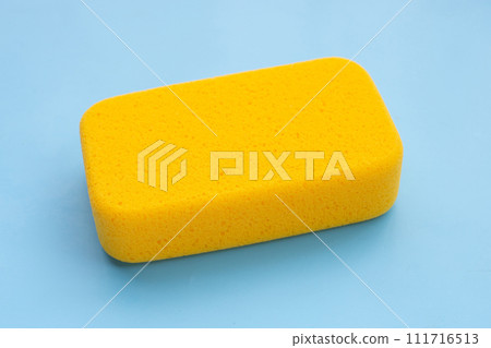 Yellow sponge on blue background. Yellow sponge on blue background. 111716513