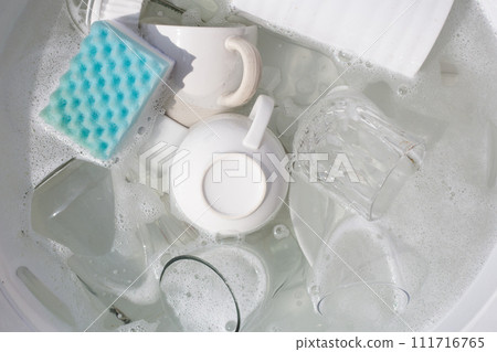 Washing used drinking glasses and cups 111716765