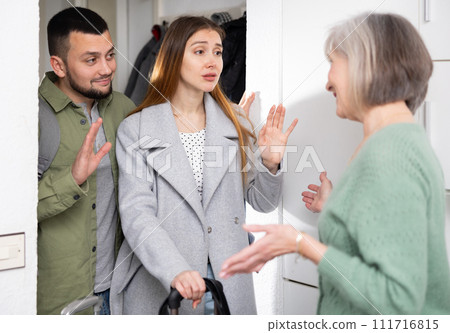 Couple saying goodbye to senior woman 111716815