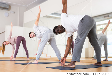 African american man doing Revolved Wide Legged Forward Bend Pose African american man doing Revolved Wide Legged Forward Bend Pose 111717003